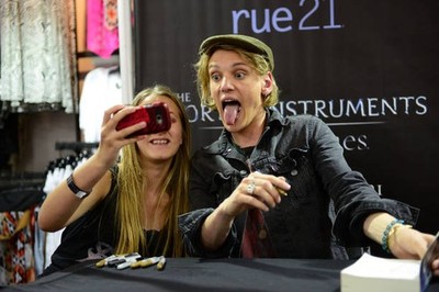 Jamie Campbell Bower poses for a picture while signing autographs - Old Photo 1