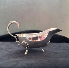 Silver Plated Sauce Boat With claw feet & scroll handle.