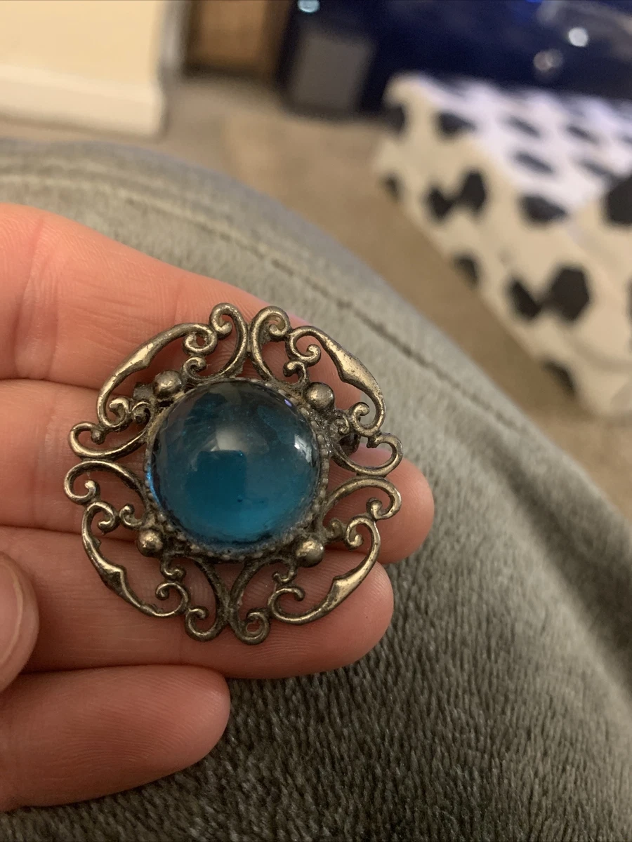 Blue stone brooch deals