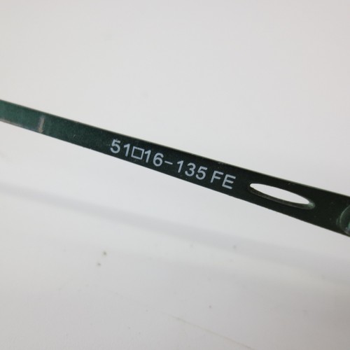 Green metal semi rimless oval eyeglass frames with white printed text reading “51016–135 FE” and a cutout lens tab.