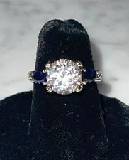 JVC QVC HUGE SHOWY CENTER STONE WITH BLUE SIDE STONES.  SIZE 6. BRAND NEW.