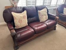 Burgundy Leather Tufted Sofa, Carved Wood Frame, Padded Arms, Cushioned Back