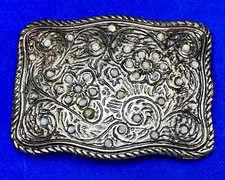 white stone accented silver color flower swirl belt buckle with thick boarder