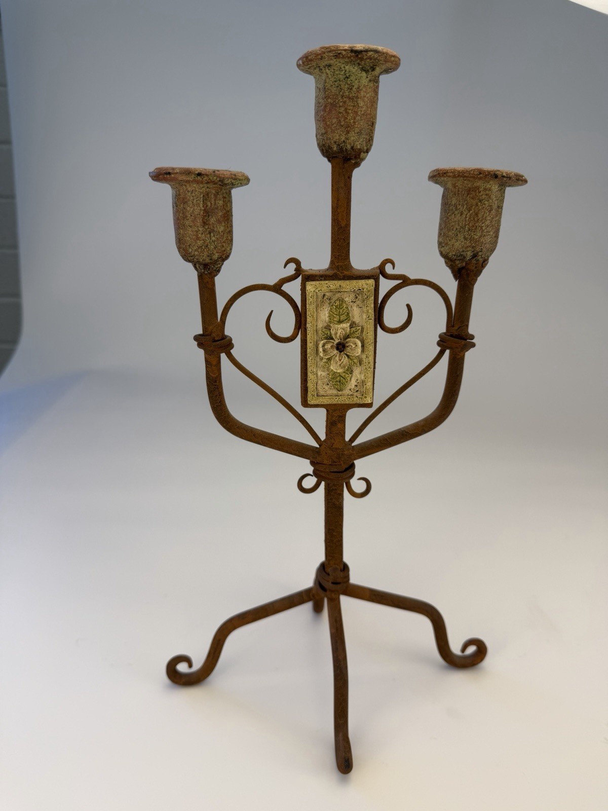 Tall three-tier wrought iron candelabra with dark patina finish