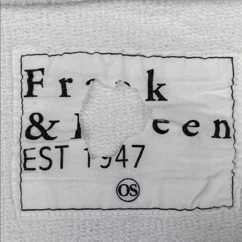 White fabric tag on red-print neck of Capelet with black text “Frank & Eileen EST 1947” and “OS” certification.