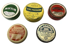 Nice assortment of 5 vintage fly line dressing tins, Hardy, etc.