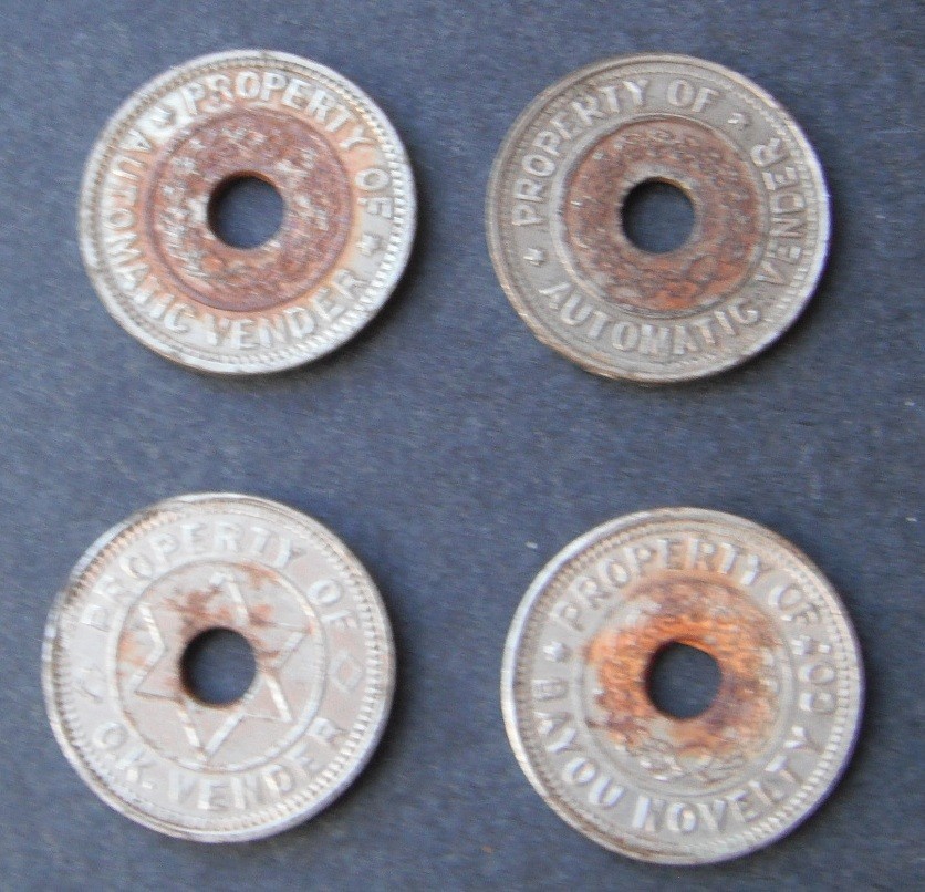 Tokens-4 items..O.K. Vendor+Bayou Novelty+Automatic Vendor--center hole-rust--no