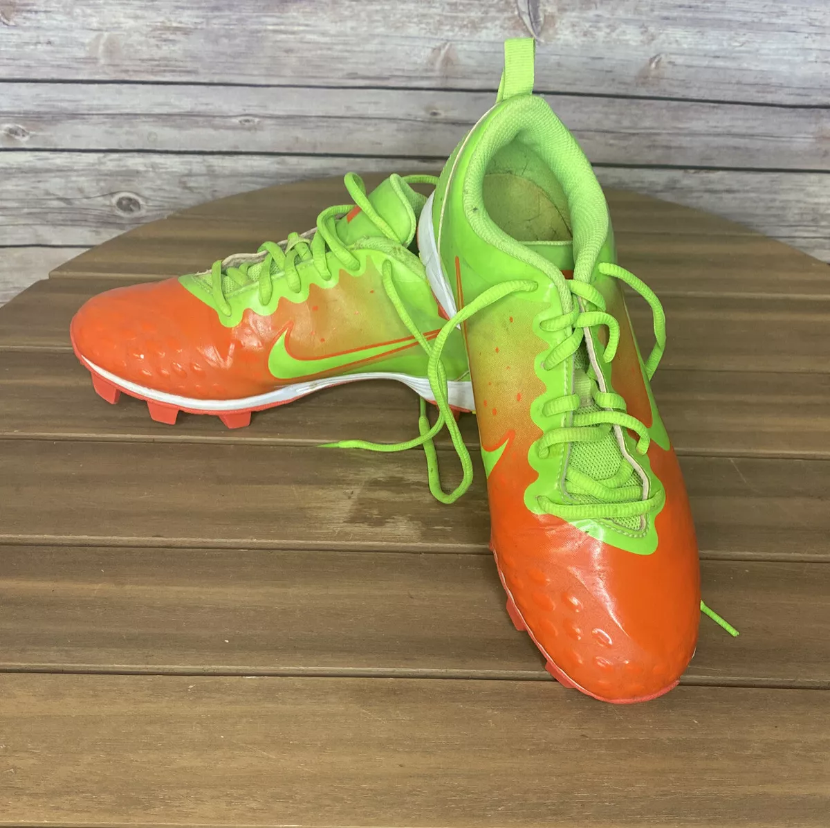 Orange and store green baseball cleats