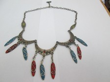 T BAR FASTENING CHAIN NECKLACE WITH MULTICOLOURED ENAMELED PENDANTS.