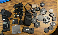 Misc Lot of Nikon accessories: battery grips, lens caps, tripod head, etc