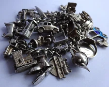 Vintage heavy solid silver charm bracelet &many curious silver charms inc moving