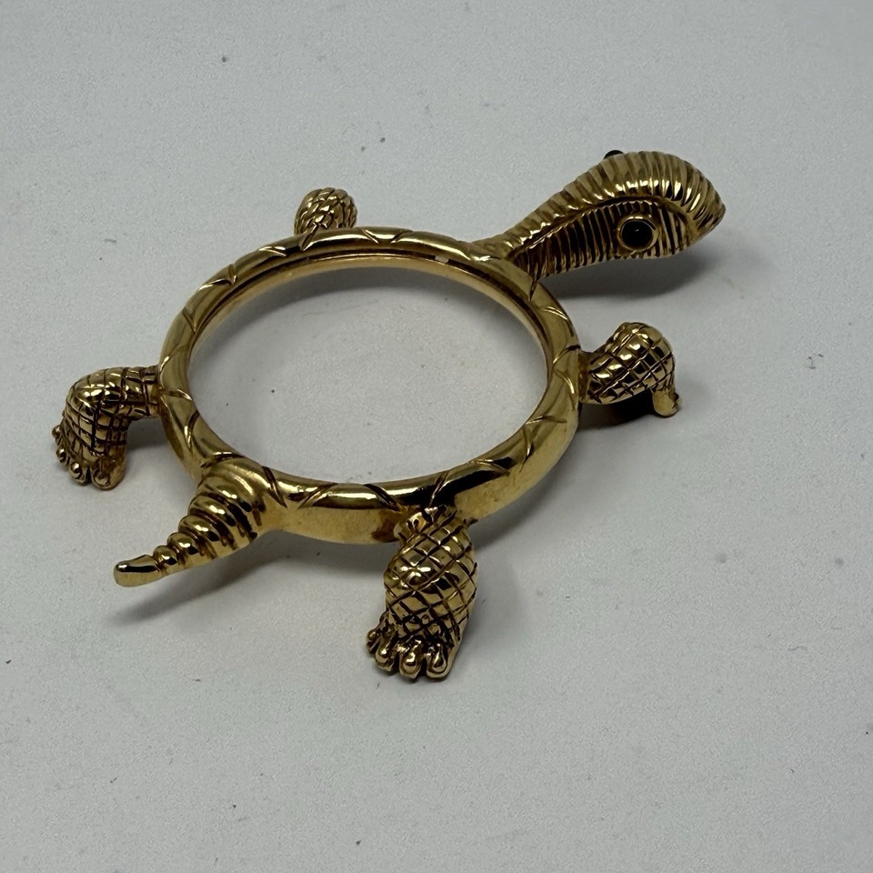 A Joan Rivers-designed gold-tone turtle magnifying glass — designer kitsch meets actual desk utility, and it's a conversation piece every single time.