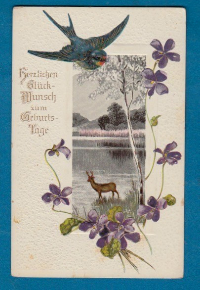 Birthday greetings embossed postcd/ in German/ flying bluebird/deer/lake/violets