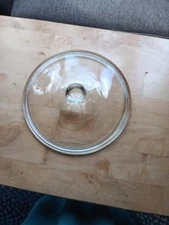 9 3/4 in round clear glass replacement lid with knob. 374