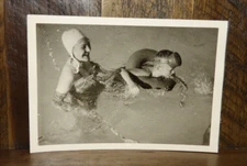 Found  Snapshot Mother and son playing in the pool