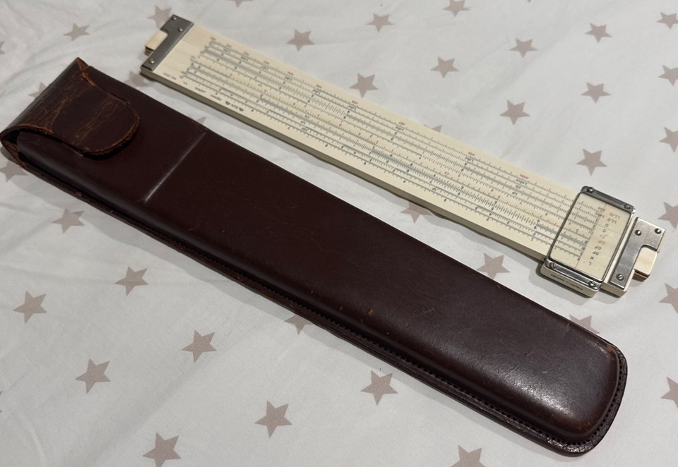 A Japanese-made bamboo slide rule — yes, BAMBOO — paired with a Post Versalog leather case; a rare, tactile piece of mid-century engineering craftsmanship.