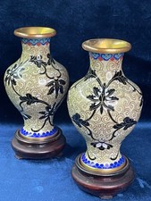 Pair of cloisonné vases with black foliage design on cream ground