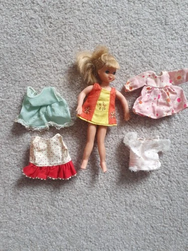 Vintage 1965 Mattel Tutti doll in original outfit with some clothing