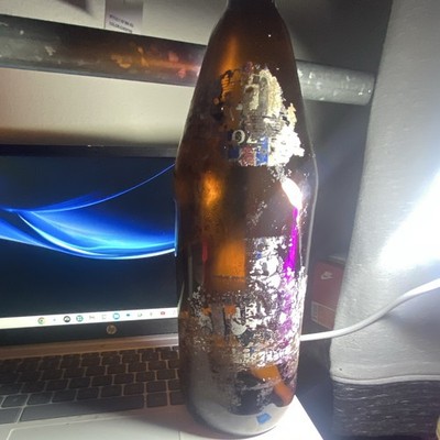 Vintage Brown Amber Glass Beer Bottle with Partial Worn/Peeling Label