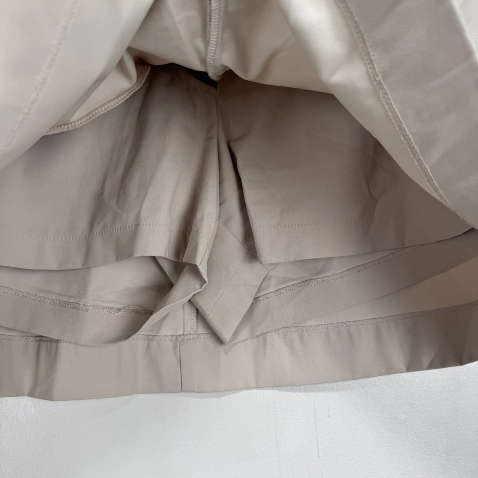 Falda corta de golf Nike Tech para mujer talla 4 beige caqui Dri-Fit rendimiento absorbente Foto 3 de 4