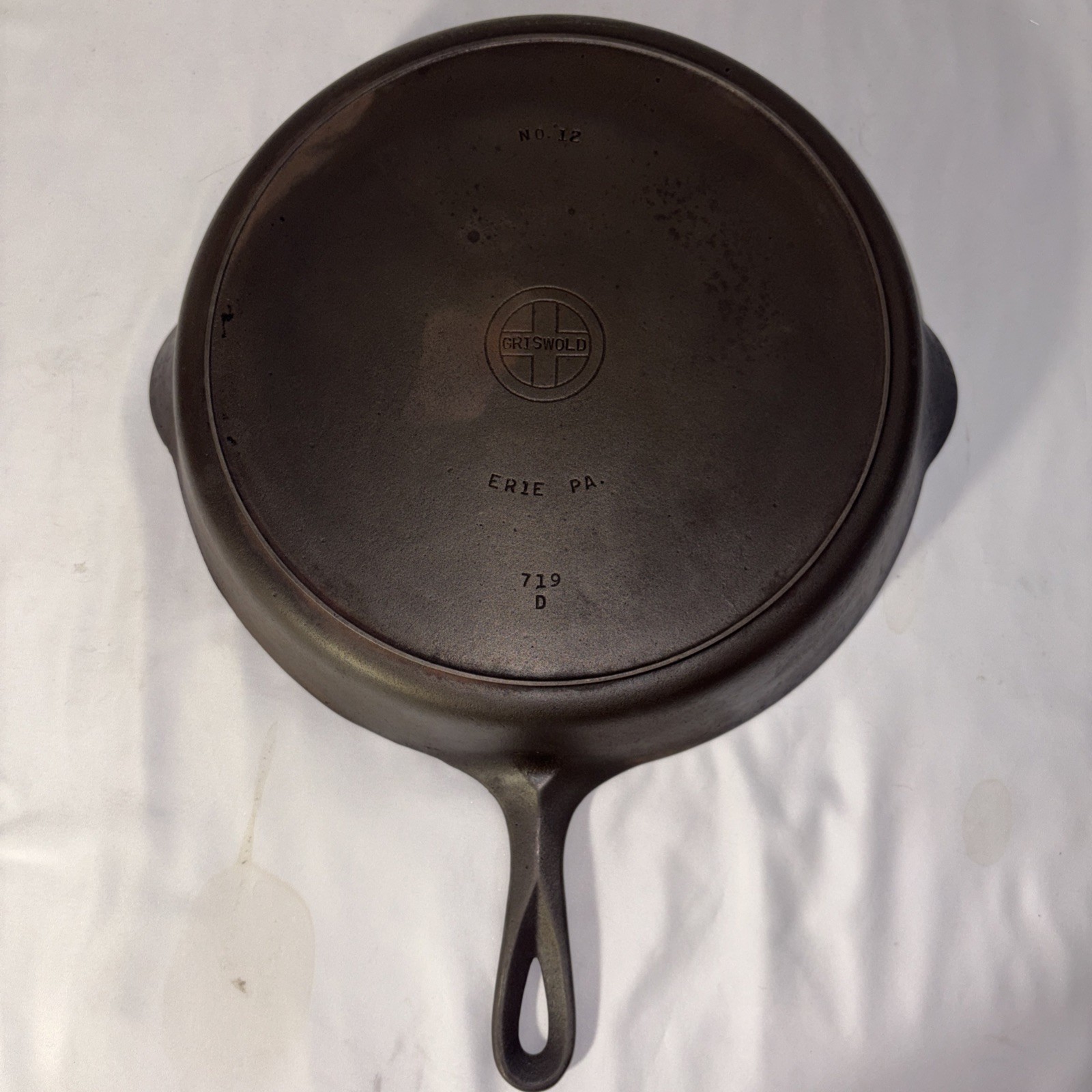 Vintage Griswold No. 12 cast iron skillet with heat ring and small logo.