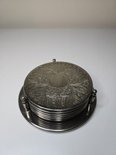 vintage set of silver-plated drinks coasters with an embossed floral design