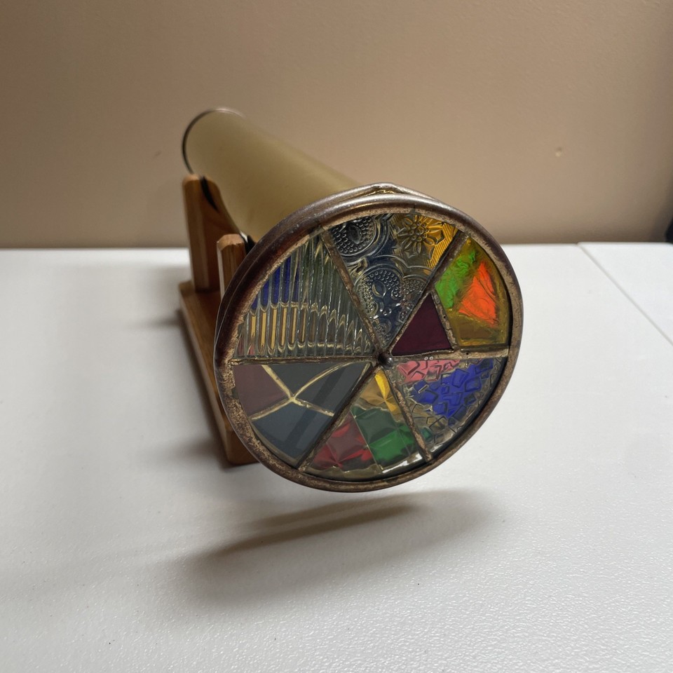 A 1988 Janice Chesnik / Koch collaboration kaleidoscope on a wood stand — two named artists on one piece from the golden era of American kaleidoscope art.