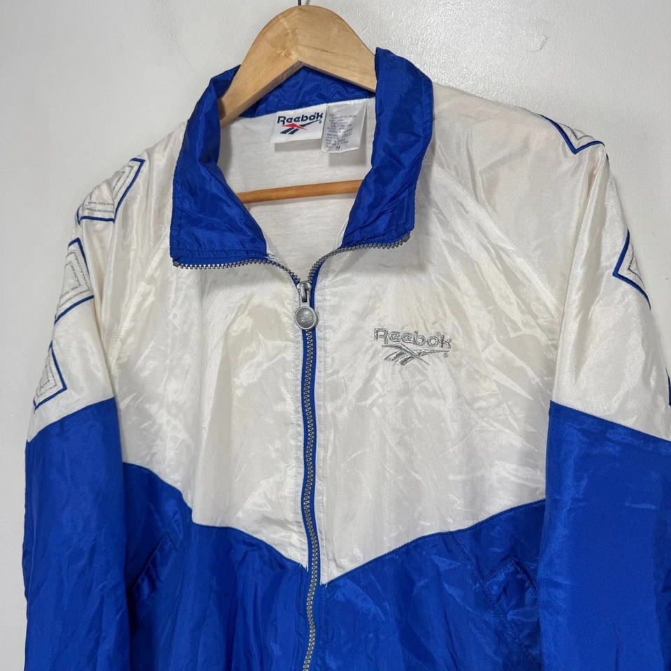 Chaqueta cortavientos Reebok vintage para mujer mediana blanca azul plateada años 90 cremallera completa Foto 3 de 4