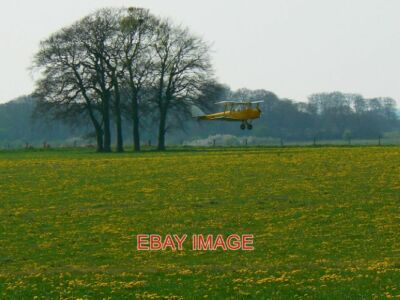 PHOTO  DE HAVILLAND TIGER MOTH IS ABOUT TO TOUCH DOWN AFTER A PRACTICE SESSION '