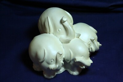 Four Very Heavy White Stacked Elephants