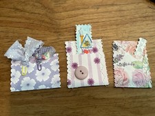 Three Hand made junk journal pockets. with tags, paper clips, notecards,