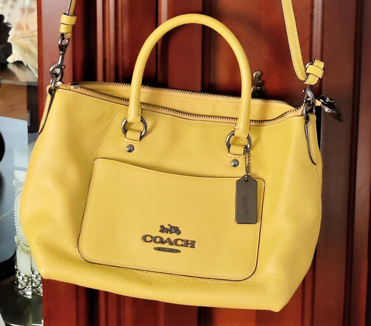 Premium Photo | A yellow leather purse on a black wood table