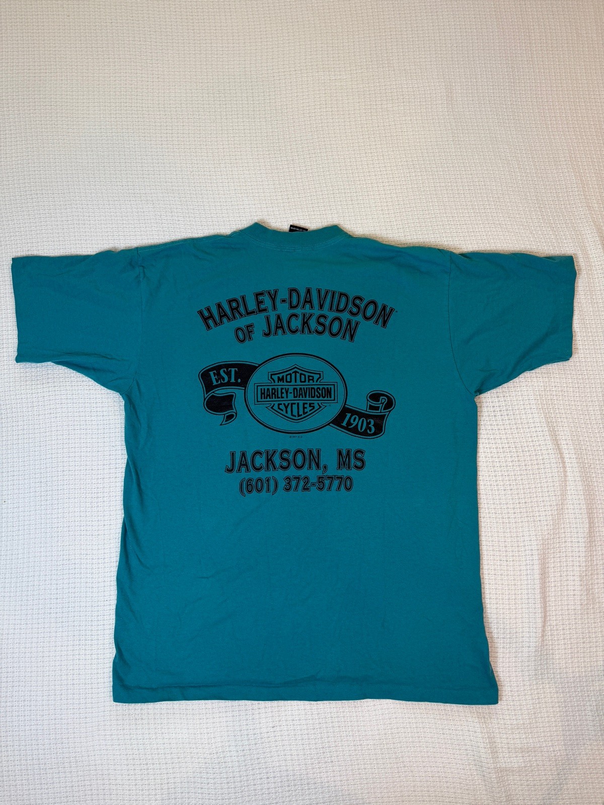 Teal Harley-Davidson men’s XL T-shirt with black “Est. 1903 Jackson, MS” text and logo on back.