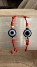 2 red string evil eye bracelets