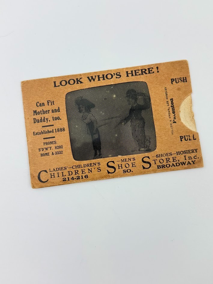 A lenticular advertising card from a vanished NYC Broadway department store — a moving-image antique that's equal parts optical illusion, street history, and conversation piece.