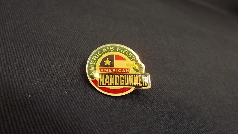 Vintage American Handgunner Magazine “America’s First” hat lapel pin 7/8" Flag