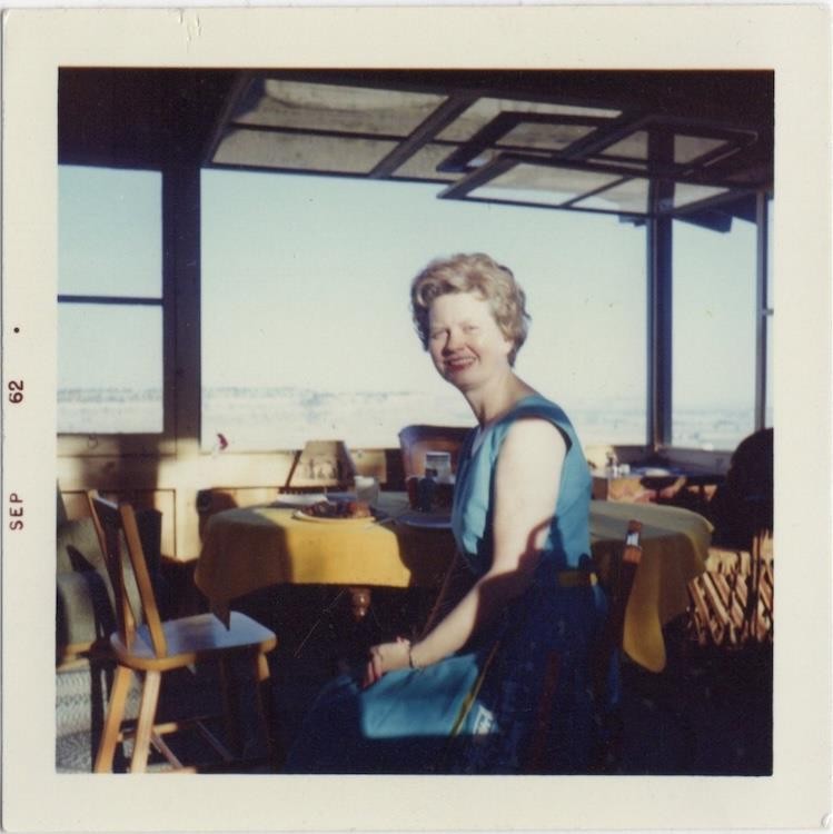 Woman at sunny cafe table, 1962