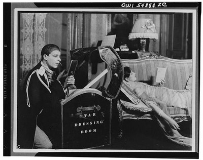 1940s Dressing Room Man Putting on Makeup Woman Reclining Sofa Mirror