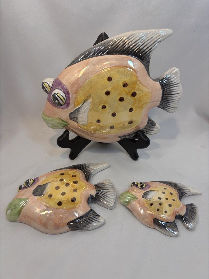 A set of 3 colorful MCM ceramic school-of-fish wall plaques — the kind of retro wall grouping that makes a whole room feel curated.