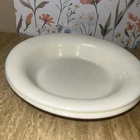 A 10-inch wide, 2-inch tall white milk glass serving bowl by Corning. Set Of 2