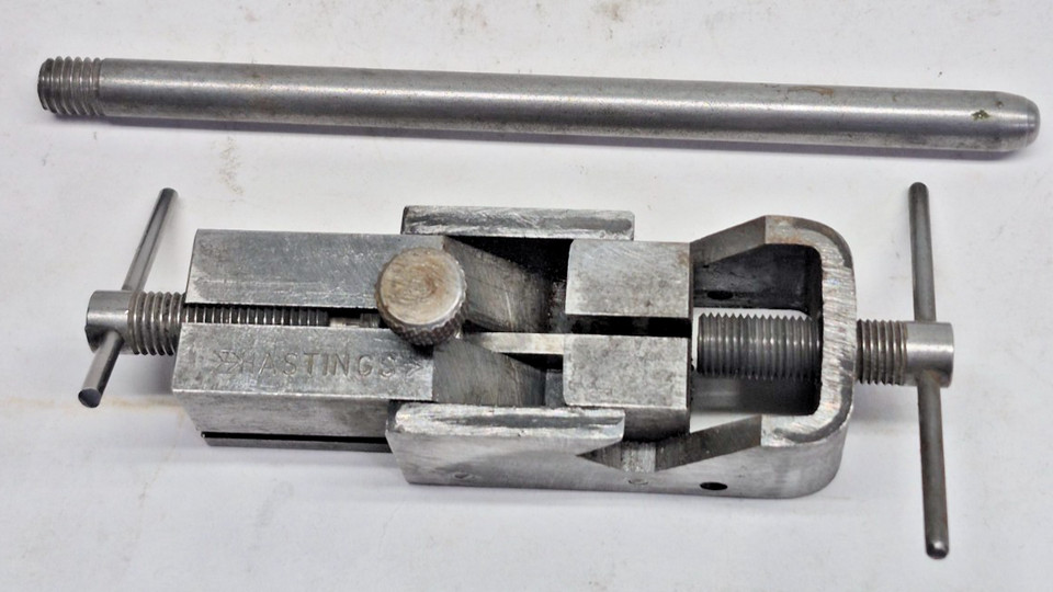 A boxy, mysterious-looking vintage automotive valve-ring tool that looks more like a prop from a Cold War spy film than a garage item — still in its original box.