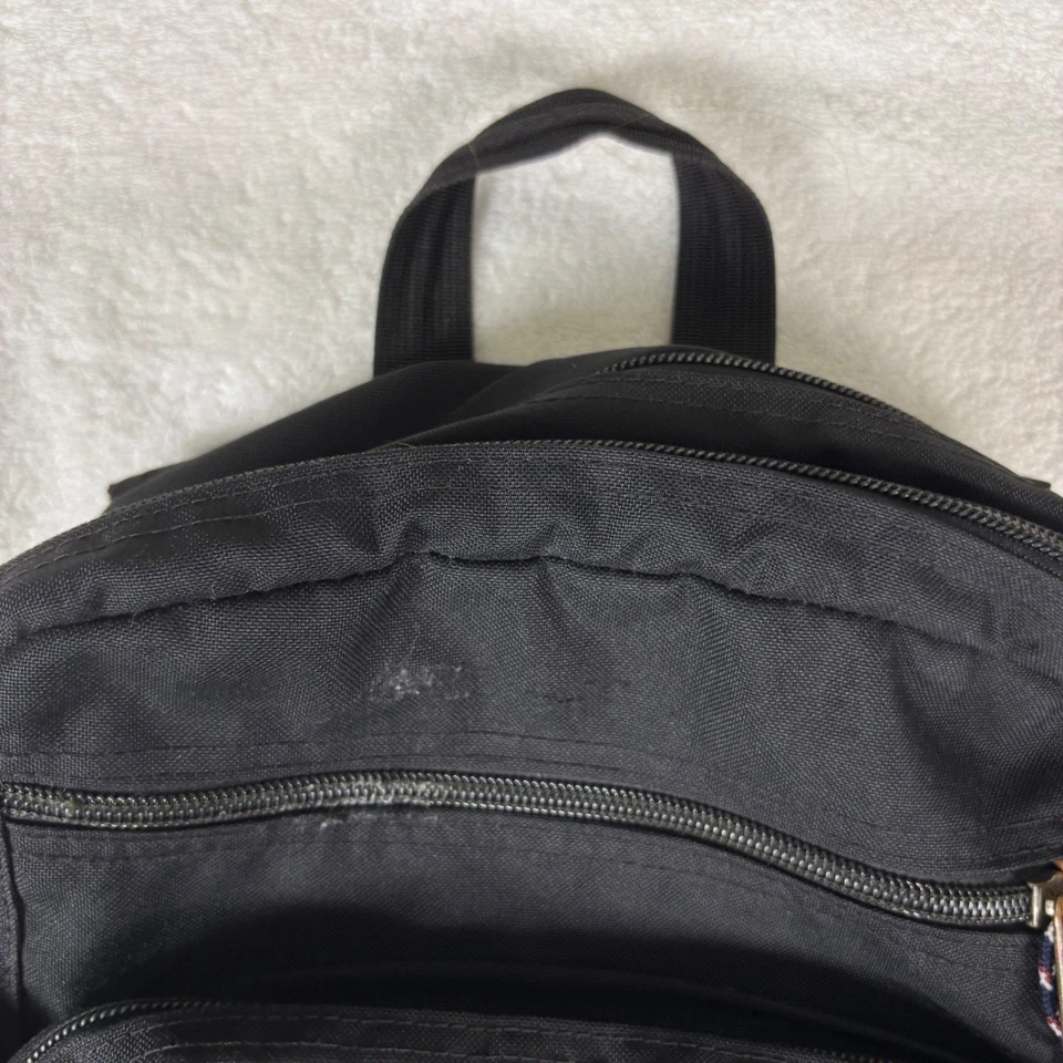 Mochila Jansport Cool Student Negra Cuero Marrón Bolsillos Inferior Malla Lateral Foto 3 de 4