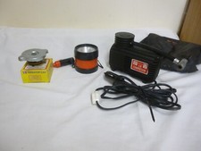 vintage car items,plug in light ,air compressor and a radiator cap