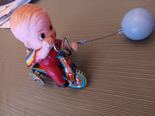 BOY RIDING BICYCLE TIN TOY WIND UP WITH BALL AND BALLOON PRE-OWNED