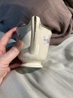 Cream ceramic mug with gold rim and handle, floral print in blue and white, labeled “1947 Homer Laughlin Made in USA.”