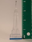 Clear vintage Lucite Empire State Building miniature with blue base, shown beside green ruler measuring approximately 3 inches tall.