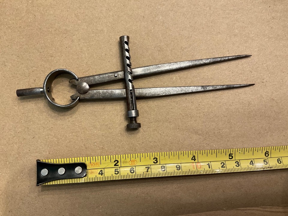 A 110-year-old precision machinist's divider from Union Caliper Co. — a tactile relic from early American industrial craftsmanship that looks like it belongs in a steampunk museum.