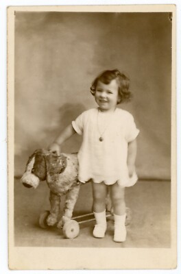PHOTO CARD, a child with a toy dog wheeled dog