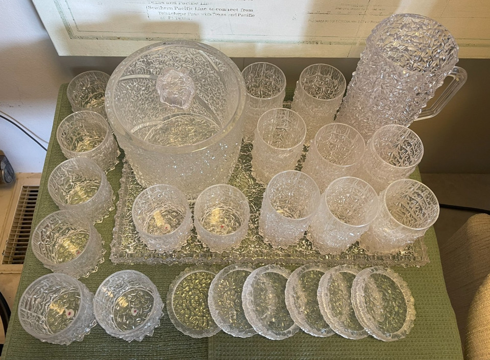 A complete MCM Lucite barware set — ice bucket, pitcher, glasses, tray, and coasters — the kind of matching ensemble that makes a home bar look like it belongs in a Rat Pack movie.