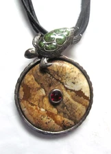 pendant necklace with a sea turtle atop  round natural stone